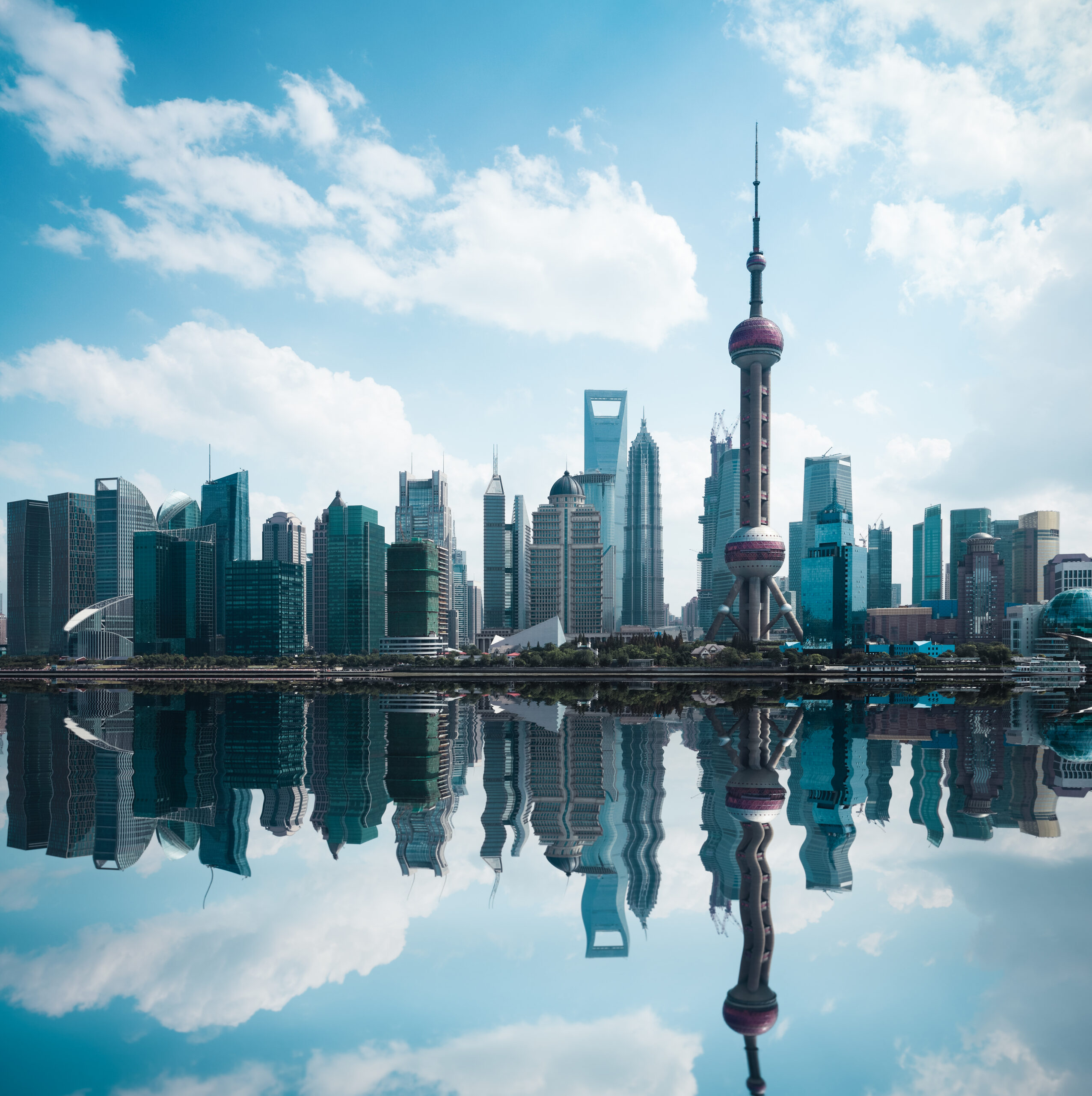 shanghai,skyline,against,a,blue,sky,with,reflection
