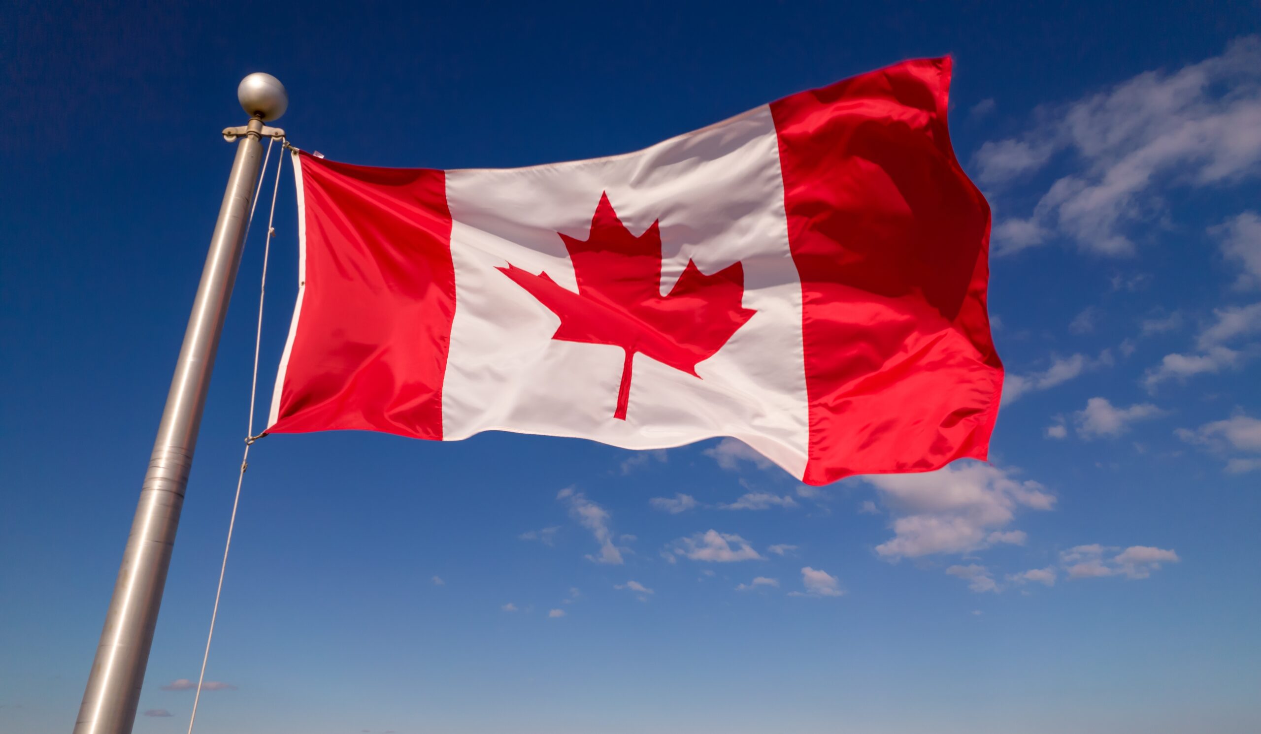 canadian,flag,flying,at,summer,blue,sky.,canadian,flag,waving